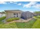 Enjoy the outdoors in this home's backyard with a screened porch and well-maintained landscaping at 31814 Larkenheath Dr, Wesley Chapel, FL 33543