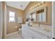 Bright bathroom features a single sink vanity, neutral walls, and tiled floors at 31814 Larkenheath Dr, Wesley Chapel, FL 33543
