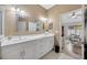 Bright bathroom features a double sink vanity, neutral walls, and tiled floors at 31814 Larkenheath Dr, Wesley Chapel, FL 33543