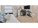 Multi-use bedroom as office with a daybed, neutral walls, wood-look floors, and a functional desk area at 31814 Larkenheath Dr, Wesley Chapel, FL 33543