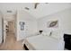 Bright bedroom featuring neutral walls, light wood floors, and hallway access at 31814 Larkenheath Dr, Wesley Chapel, FL 33543