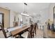 Open floor plan showing dining area with wood furniture that flows into the living room and kitchen at 31814 Larkenheath Dr, Wesley Chapel, FL 33543