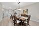 Open concept dining room showcasing a wood table, stylish chandelier, and bright kitchen at 31814 Larkenheath Dr, Wesley Chapel, FL 33543