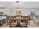 Spacious dining area featuring an elegant wood table, chandelier, and an open floor plan at 31814 Larkenheath Dr, Wesley Chapel, FL 33543