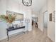 Elegant foyer with light wood floors, stylish lighting, and archway leading to the living spaces at 31814 Larkenheath Dr, Wesley Chapel, FL 33543