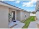 Neutral exterior of home featuring a side entry, neatly landscaped pathway, and privacy at 31814 Larkenheath Dr, Wesley Chapel, FL 33543