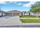 Charming single-story home with a well-manicured lawn and a two-car garage, enhancing its curb appeal at 31814 Larkenheath Dr, Wesley Chapel, FL 33543