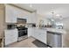 Modern kitchen with white cabinetry, stainless steel appliances, and an open layout for easy entertaining at 31814 Larkenheath Dr, Wesley Chapel, FL 33543