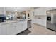 Modern kitchen with white cabinets, stainless steel appliances, and an open design for seamless living at 31814 Larkenheath Dr, Wesley Chapel, FL 33543