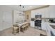 Modern kitchen with white cabinetry, stainless steel appliances, and a stylish dining area at 31814 Larkenheath Dr, Wesley Chapel, FL 33543