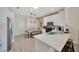 Modern kitchen featuring sleek white cabinets, stainless steel appliances, and a cozy dining area at 31814 Larkenheath Dr, Wesley Chapel, FL 33543