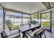 Screened patio with dining area and backyard views, perfect for outdoor entertaining and relaxation at 31814 Larkenheath Dr, Wesley Chapel, FL 33543