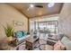 Relaxing covered patio featuring wicker seating, plants, ceiling fan, and view of the outdoor dining area at 31814 Larkenheath Dr, Wesley Chapel, FL 33543