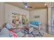 Comfortable covered patio with wicker furniture, ceiling fan, and a view through sliding glass doors at 31814 Larkenheath Dr, Wesley Chapel, FL 33543