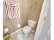 This well-lit powder room has a decorative mirror and neutral wall color at 31814 Larkenheath Dr, Wesley Chapel, FL 33543