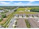 Aerial view of a residential neighborhood featuring well-maintained homes, green spaces, and nearby amenities at 3216 Bryant Park Dr, New Port Richey, FL 34655
