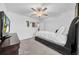 Bedroom featuring carpeting, fan and fixture, TV and dresser, and wall decor above the bed at 3216 Bryant Park Dr, New Port Richey, FL 34655