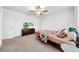 Neat bedroom with cozy carpeting, fan and fixture, and a TV with a view of the house exterior at 3216 Bryant Park Dr, New Port Richey, FL 34655
