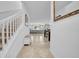 Inviting entryway with staircase and bench leading to an open-concept living and dining area at 3216 Bryant Park Dr, New Port Richey, FL 34655