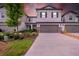 Charming two-story home features a two-car garage, manicured lawn and lush landscaping at 3216 Bryant Park Dr, New Port Richey, FL 34655