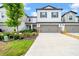 Charming two-story home features a two-car garage, manicured lawn and lush landscaping at 3216 Bryant Park Dr, New Port Richey, FL 34655