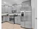 Kitchen with gray cabinets, granite counters, and stainless steel appliances at 3216 Bryant Park Dr, New Port Richey, FL 34655