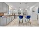 Modern kitchen with gray cabinets, stainless steel appliances, granite countertops, and island seating at 3216 Bryant Park Dr, New Port Richey, FL 34655