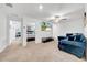Spacious living room with plush blue seating, ample natural light, and seamless access to the bedroom at 3216 Bryant Park Dr, New Port Richey, FL 34655