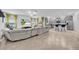 Spacious living room and kitchen with stainless steel appliances and a large sofa at 3216 Bryant Park Dr, New Port Richey, FL 34655