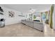 Open-concept living area featuring tile floors, a comfortable sofa, and lots of natural light at 3216 Bryant Park Dr, New Port Richey, FL 34655