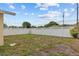 Spacious backyard featuring a well-maintained lawn and a secure white lattice-top fence for privacy at 326 Circle Dr, Palm Harbor, FL 34683