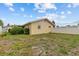 Backyard view of the house and partially fenced yard at 326 Circle Dr, Palm Harbor, FL 34683