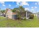 Backyard view of the house and screened in patio at 326 Circle Dr, Palm Harbor, FL 34683