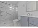 Bathroom features a marble-walled shower with sliding glass door, and updated vanity at 326 Circle Dr, Palm Harbor, FL 34683