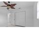 Bedroom featuring tile flooring, white walls, closet, and ceiling fan at 326 Circle Dr, Palm Harbor, FL 34683