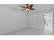 Light bedroom with a ceiling fan and a doorway view to the kitchen at 326 Circle Dr, Palm Harbor, FL 34683