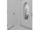 A bright white door with leaded glass detail is shown between two white doors, and above white tile at 326 Circle Dr, Palm Harbor, FL 34683