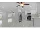 Bright, white kitchen featuring stainless steel appliances and a ceiling fan at 326 Circle Dr, Palm Harbor, FL 34683