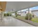 Screened patio featuring tile floor, fan, and views of the backyard at 326 Circle Dr, Palm Harbor, FL 34683