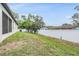 Large backyard with a white fence, offering plenty of space for outdoor activities and privacy at 344 Dartmouth Ave, Spring Hill, FL 34606