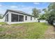 This home features a screened in porch and a large grassy backyard at 344 Dartmouth Ave, Spring Hill, FL 34606