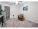 Cozy bedroom with carpet, ceiling fan, and a rocking chair near a window at 344 Dartmouth Ave, Spring Hill, FL 34606