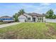 Beautiful home with a lush green lawn, a boat parked in the driveway, and appealing landscaping at 344 Dartmouth Ave, Spring Hill, FL 34606