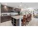 Open kitchen with granite countertops, dark cabinets, stainless steel appliances, and a center island at 344 Dartmouth Ave, Spring Hill, FL 34606