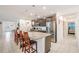 A modern kitchen with stainless steel appliances, granite countertops, and a kitchen island with bar stool seating at 344 Dartmouth Ave, Spring Hill, FL 34606