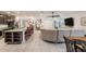 Spacious living area open to the kitchen with tile floors and a sectional sofa at 344 Dartmouth Ave, Spring Hill, FL 34606