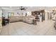 Open-concept living room with tile flooring, sectional sofa and a view of the kitchen at 344 Dartmouth Ave, Spring Hill, FL 34606