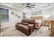 Comfortable main bedroom with a brown leather sofa, natural wood accents, and neutral decor, offering a tranquil setting at 344 Dartmouth Ave, Spring Hill, FL 34606