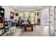 Spacious office space with tile floors, large desk, shelving and a glass door leading outside at 344 Dartmouth Ave, Spring Hill, FL 34606