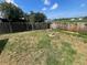 The backyard featuring a wooden fence surrounding the perimeter and grass and greenery inside at 3541 65Th Avenue E Cir, Sarasota, FL 34243